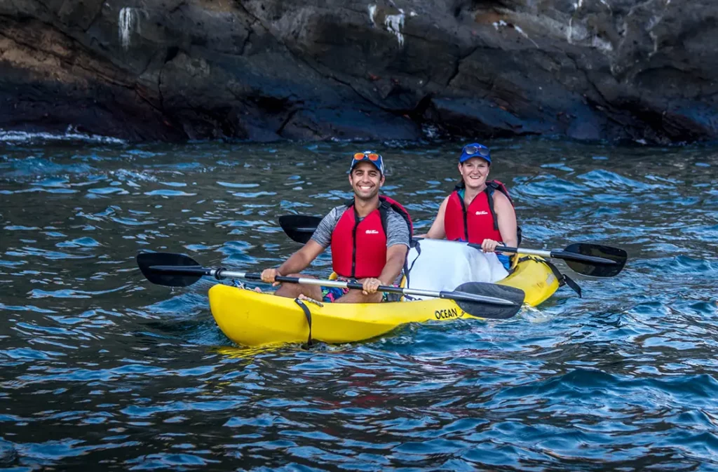 Two guests kayaking in the clear waters of Tagus Cove, Isabela Island