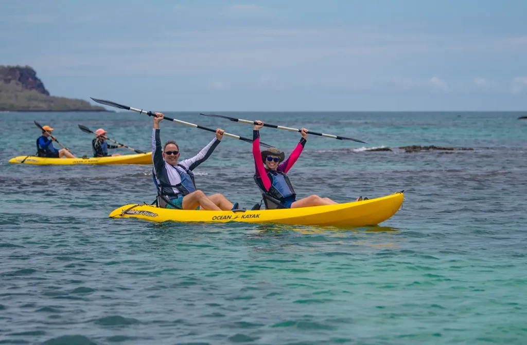 Guests kayaking at dusk during a Galapagos Islands cruise excursion